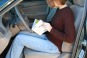 Driver reading her Owner's Manual